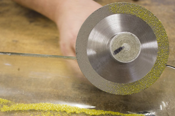 a wheel being coated with diamond grit before placed into the oven